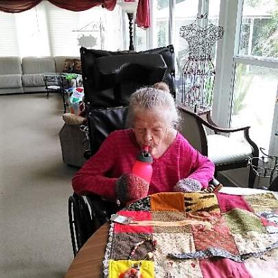 Barbara Enjoying Working with Her Memory Task Blanket in Our Oversized Florida Room